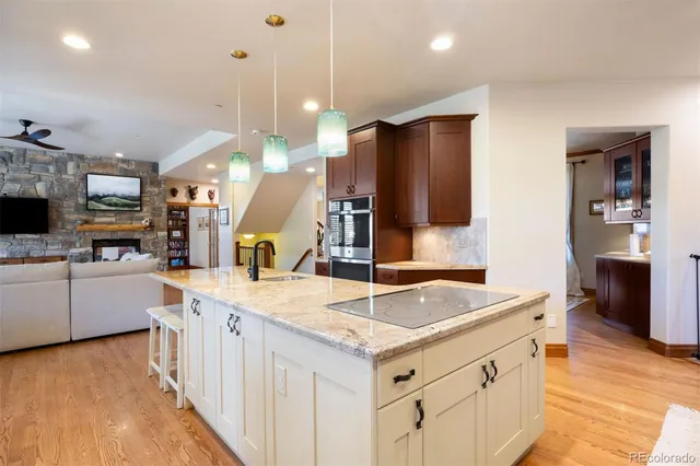 a kitchen with stainless steel appliances granite countertop a sink and a refrigerator