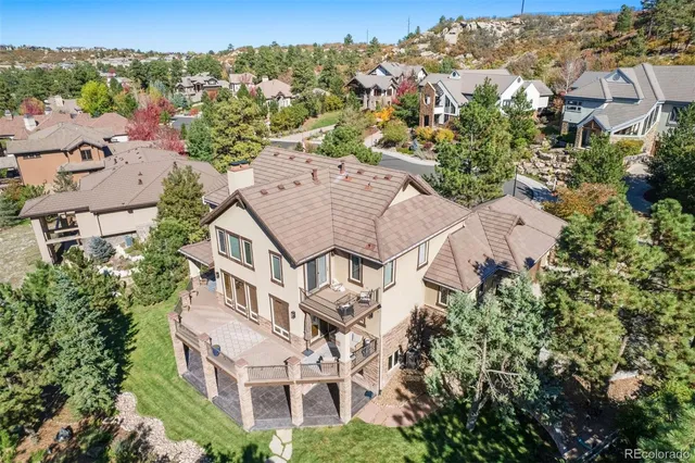 an aerial view of multiple houses with a yard