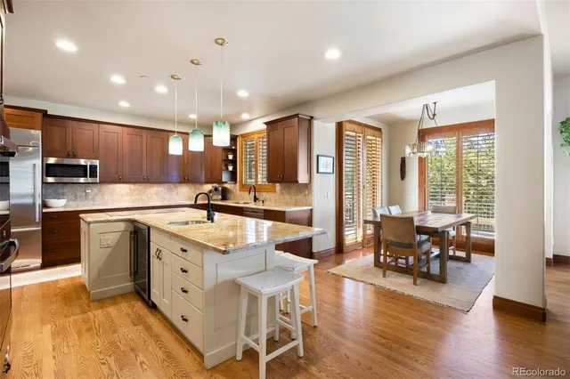 a large kitchen with lots of counter space dining table and chairs
