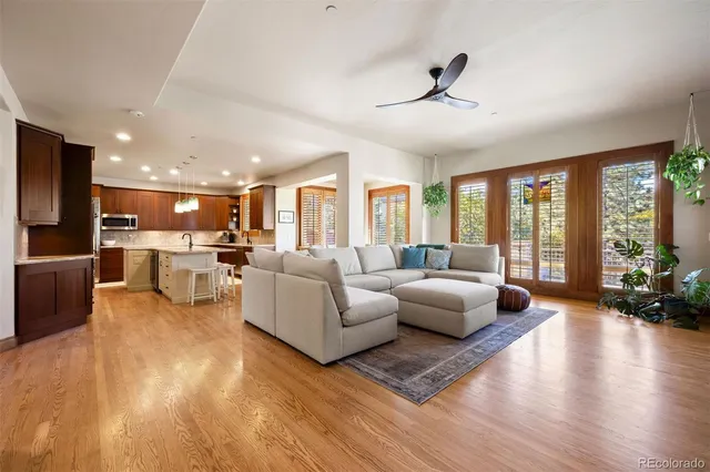 a living room with furniture or wooden floor and a large window