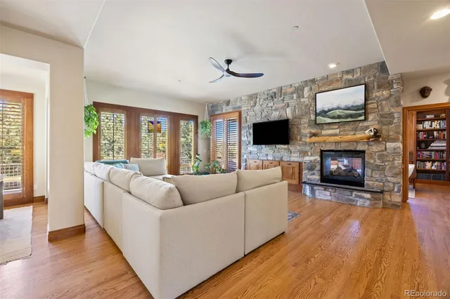 a dining room with furniture a chandelier and wooden floor