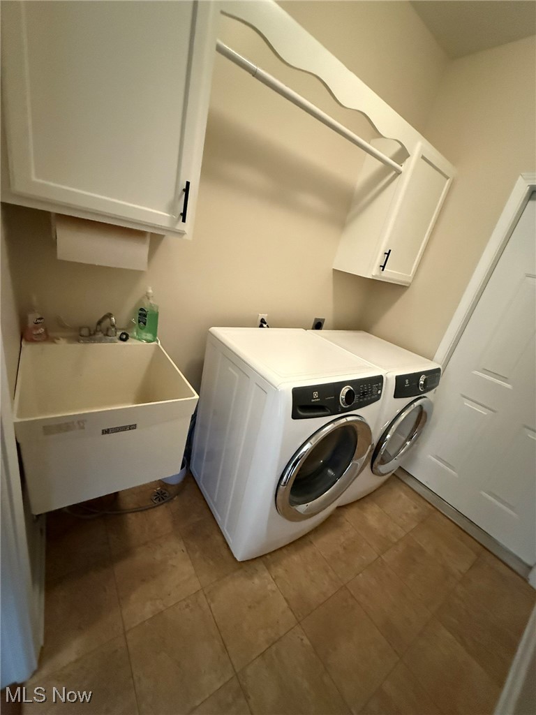 5645 Clingan Road, Unit 2D Struthers, OH 44471 - Photo 22 of 50 Laundry room with cabinet space, washer and dryer, and tile patterned flooring
