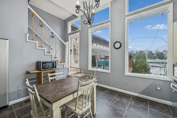 a dining room with furniture and window