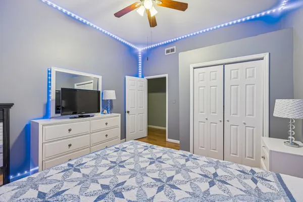 a bedroom with a bed and a flat screen tv in it