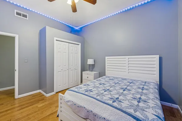a bedroom with a large bed and a chandelier
