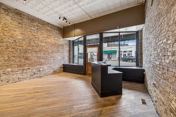 a living room with furniture floor to ceiling window and a table