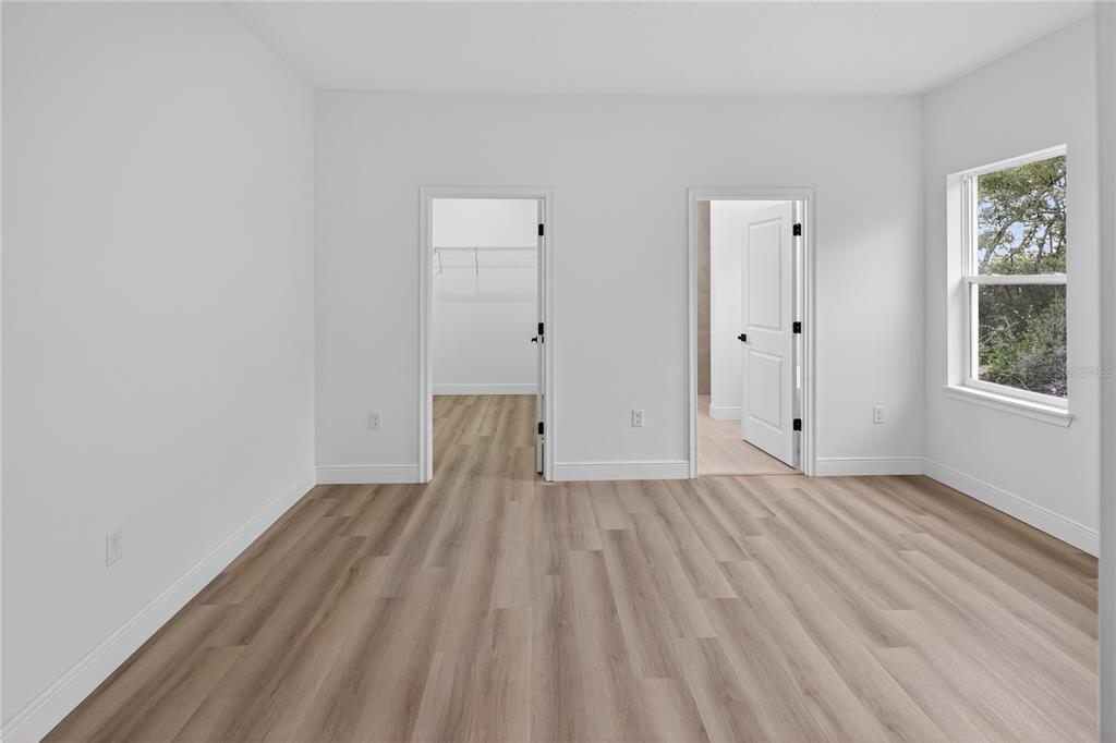 15028 Southwest 25th Circle Ocala, FL 34473 - Photo 13 of 35 a view of empty room with wooden floor and fan