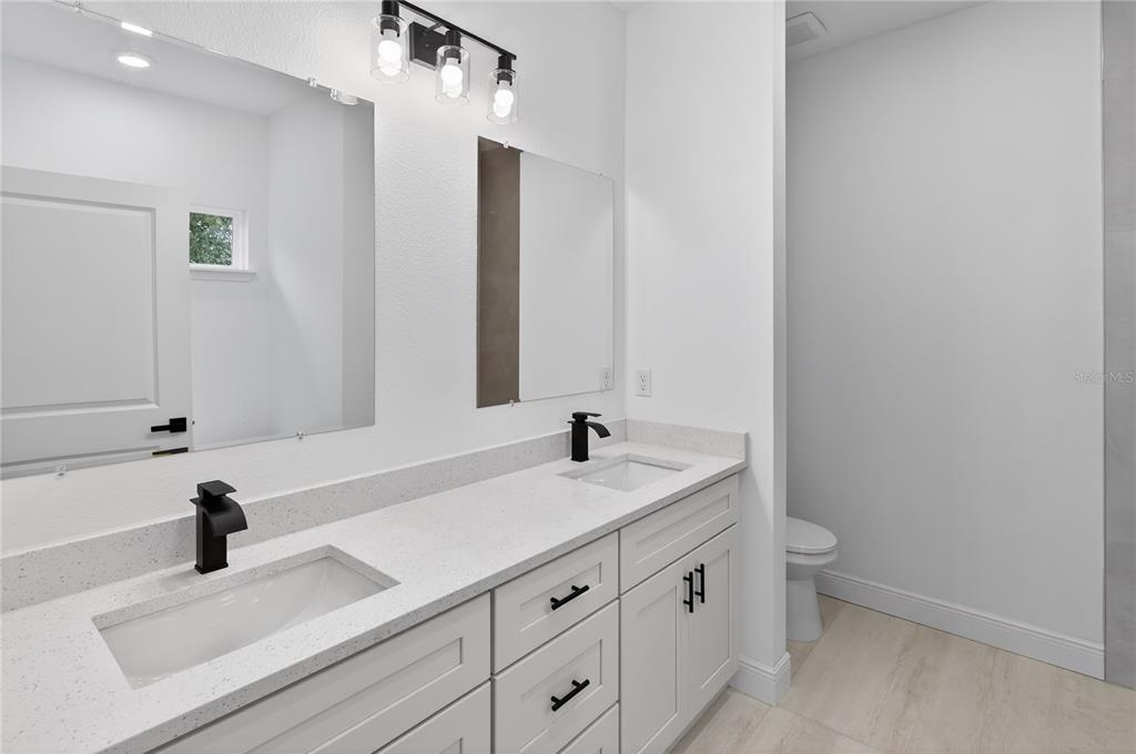 15028 Southwest 25th Circle Ocala, FL 34473 - Photo 16 of 35 a bathroom with a sink and a mirror