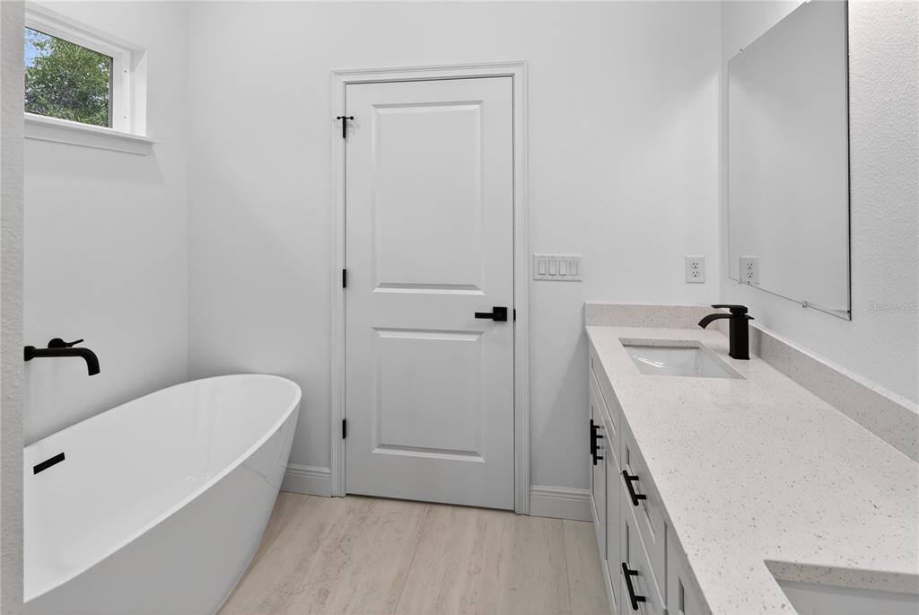 15028 Southwest 25th Circle Ocala, FL 34473 - Photo 17 of 35 a bathroom with a tub sink and vanity
