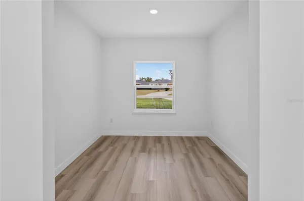 a view of room with window and hardwood floor
