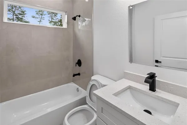 a bathroom with a sink a toilet and bathtub