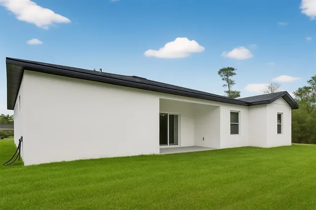 a view of a backyard with plants and a fireplace