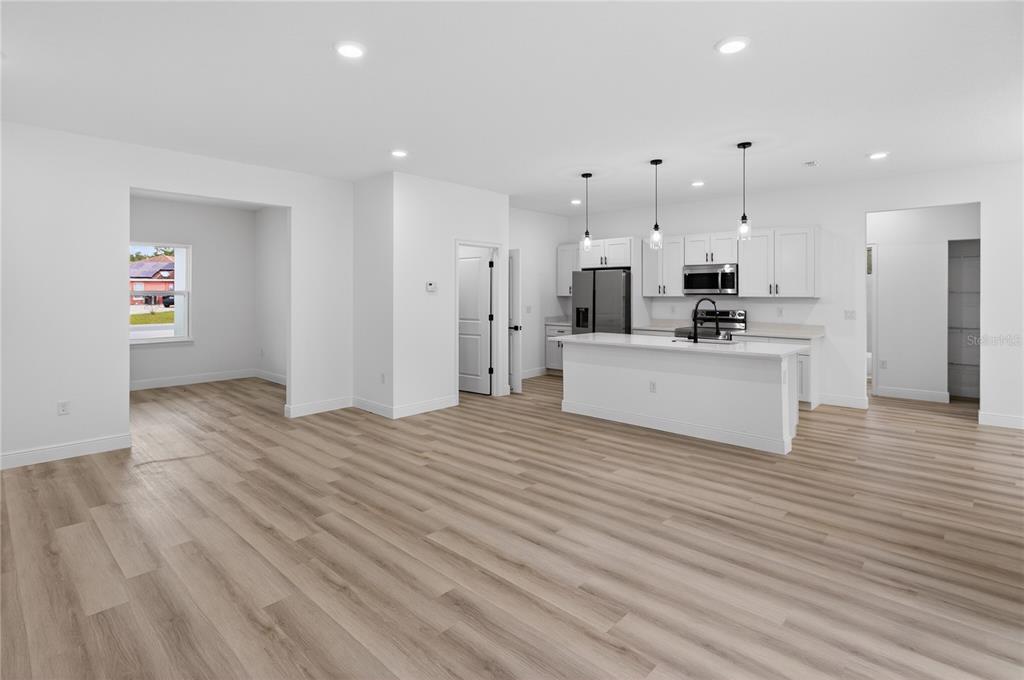 15028 Southwest 25th Circle Ocala, FL 34473 - Photo 5 of 35 a view of kitchen view wooden floor stainless steel appliances and cabinets