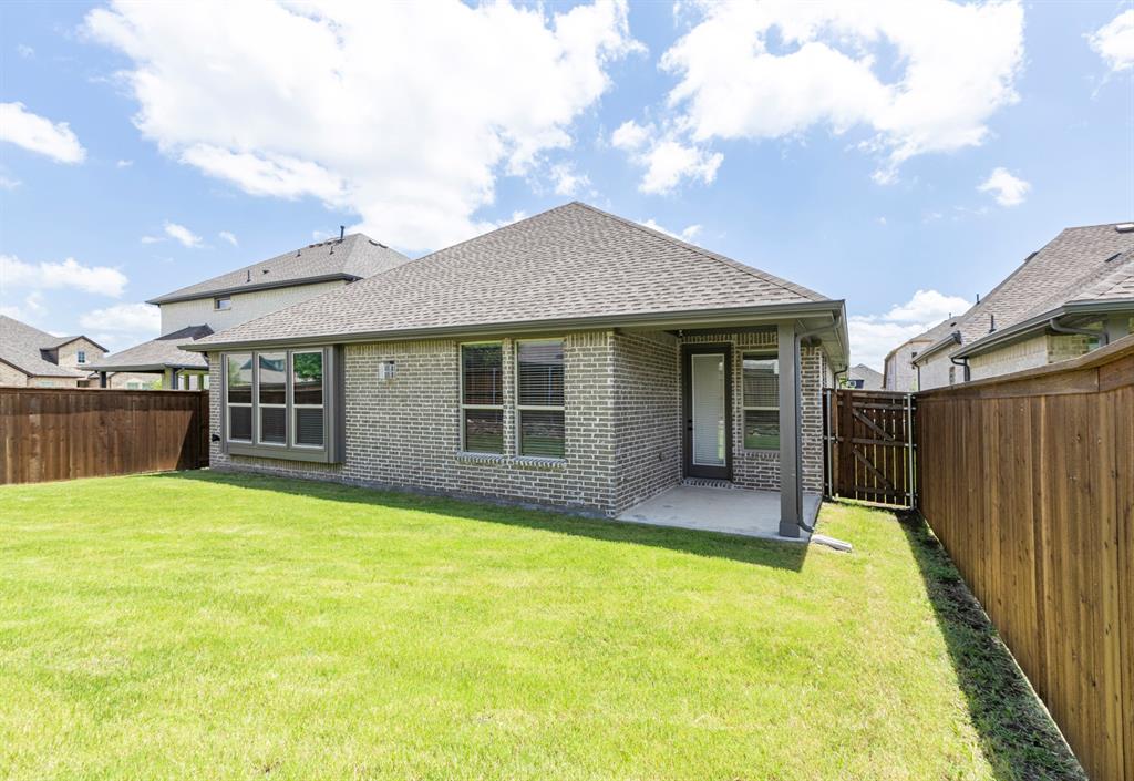 3311 Willena Road Melissa, TX 75454 - Photo 40 of 40 Expansive backyard featuring a manicured lawn, full privacy fencing, and a covered patio with direct access to the interior