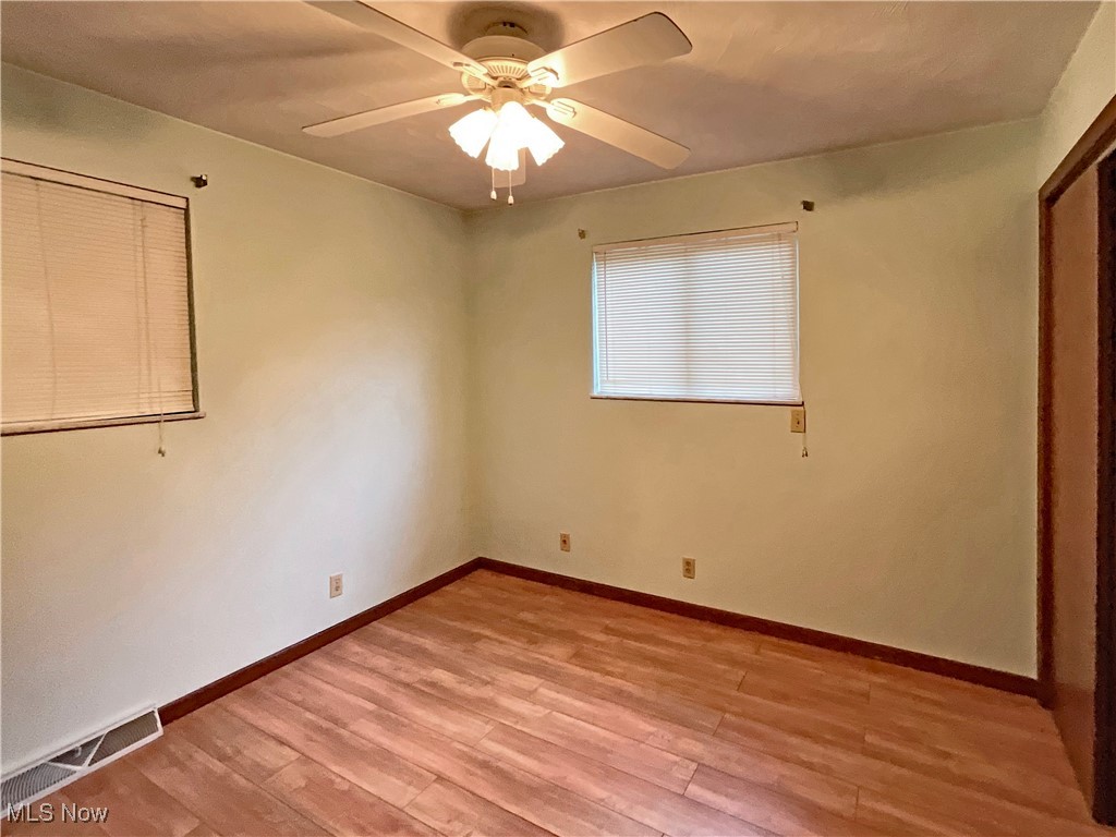 6568 Wylie Ridge Road New Cumberland, WV 26047 - Photo 12 of 28 Empty room with ceiling fan and light wood-type flooring
