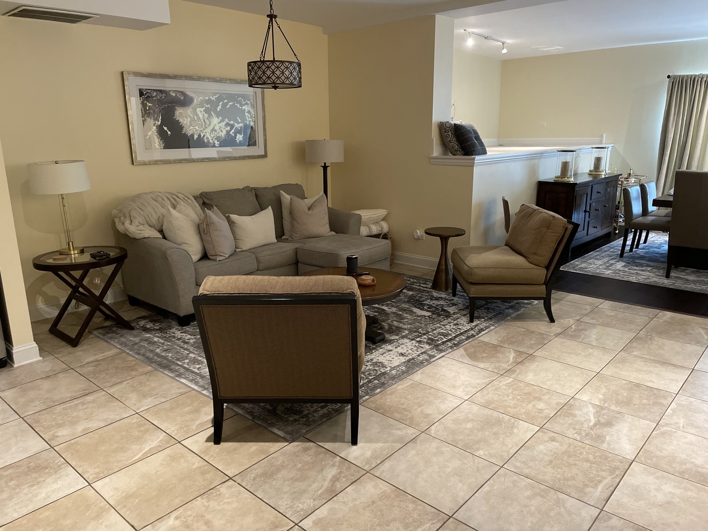 2801 West Ardmore Avenue, Unit 1A Chicago, IL 60659 - Photo 10 of 12 a living room with furniture and a dining table with wooden floor