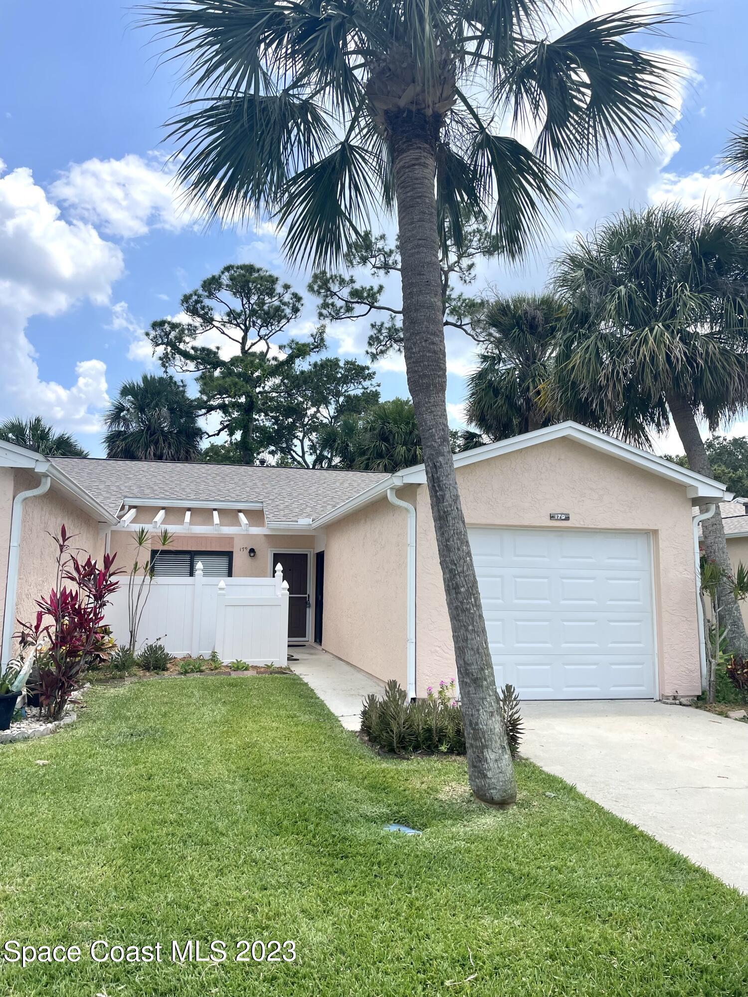 179 Shell Place, Unit 36 Rockledge, FL 32955 - Photo 17 of 20 a front view of house with yard and green space