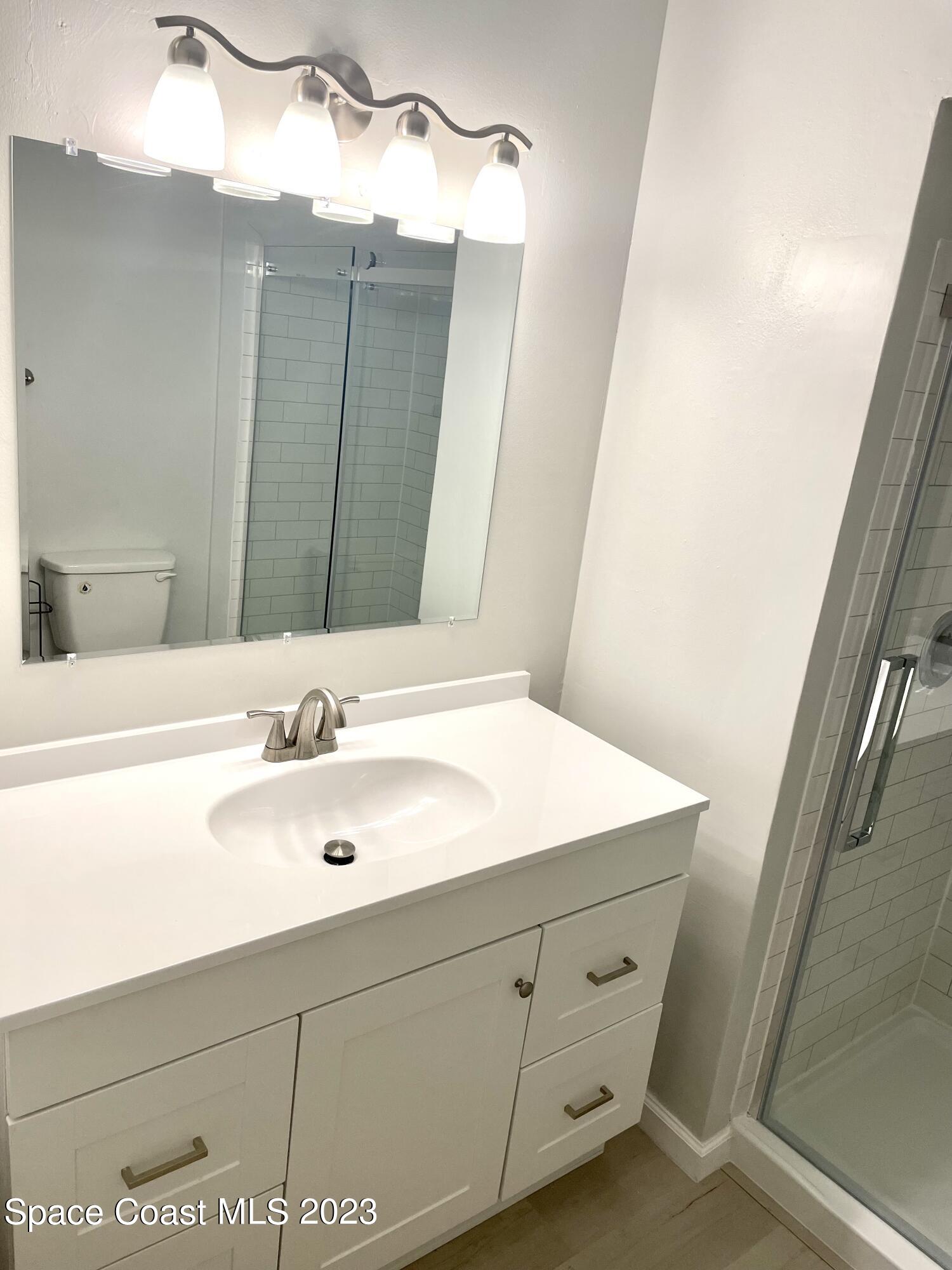 179 Shell Place, Unit 36 Rockledge, FL 32955 - Photo 10 of 20 a bathroom with a sink vanity and mirror