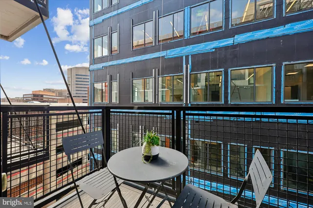 a balcony view with a seating space