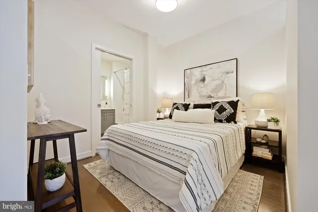 a bedroom with a bed and a painting on the wall