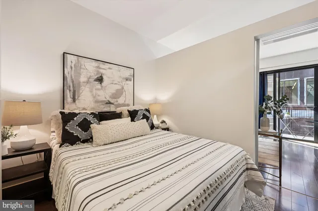 a bedroom with a bed and wooden floor