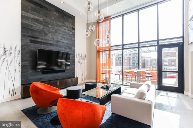 an outdoor sitting area with furniture and wooden floor