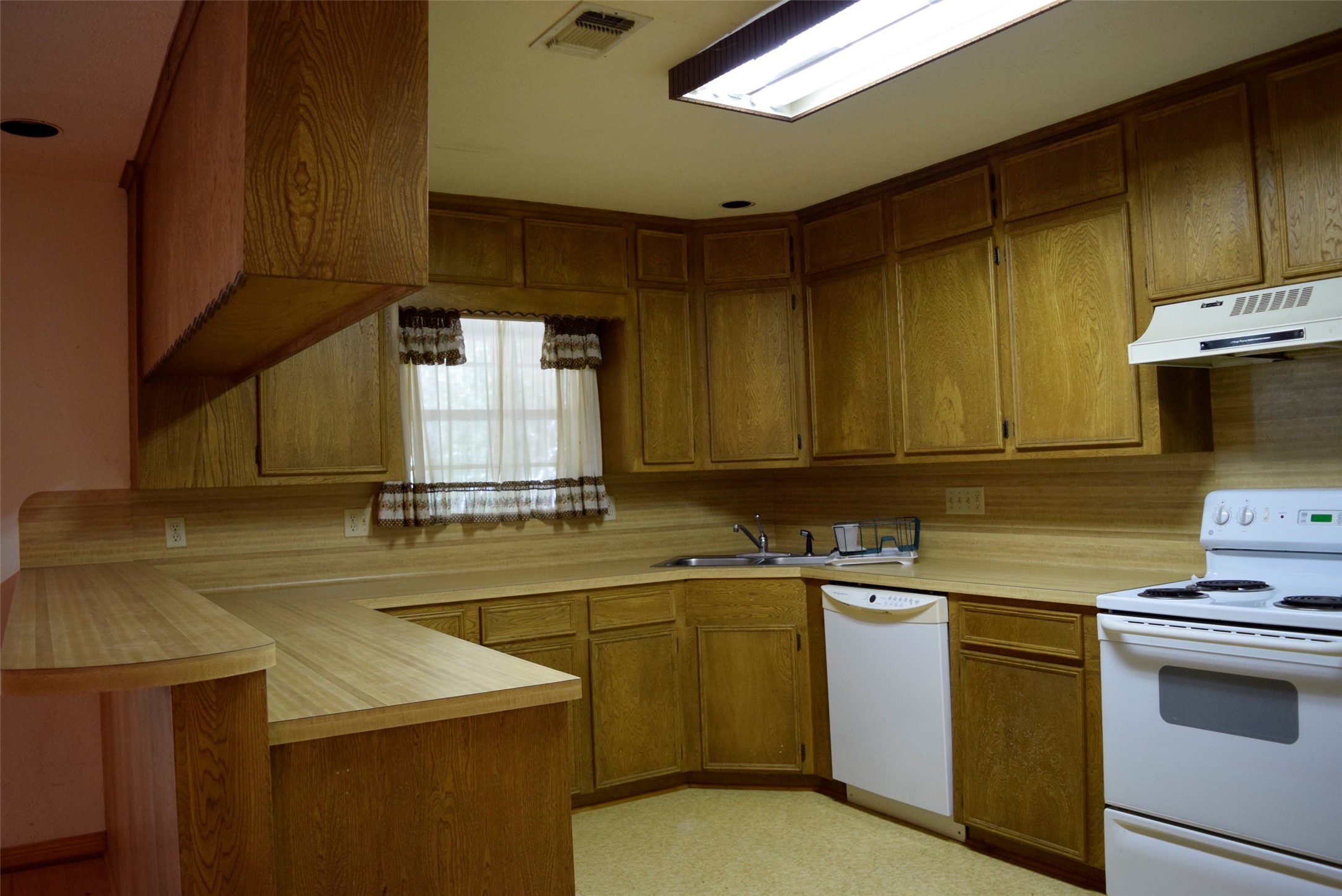 732 River Road Goodrich, TX 77335 - Photo 8 of 20 a kitchen with a sink a stove and cabinets