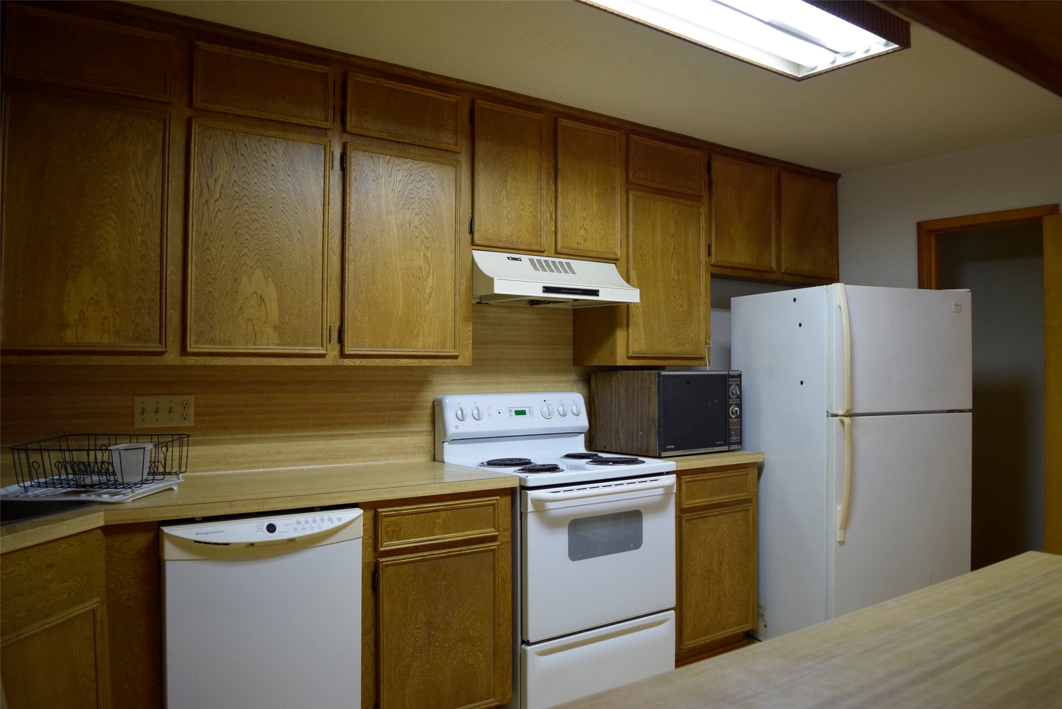 732 River Road Goodrich, TX 77335 - Photo 9 of 20 a kitchen with a refrigerator sink stove and cabinets