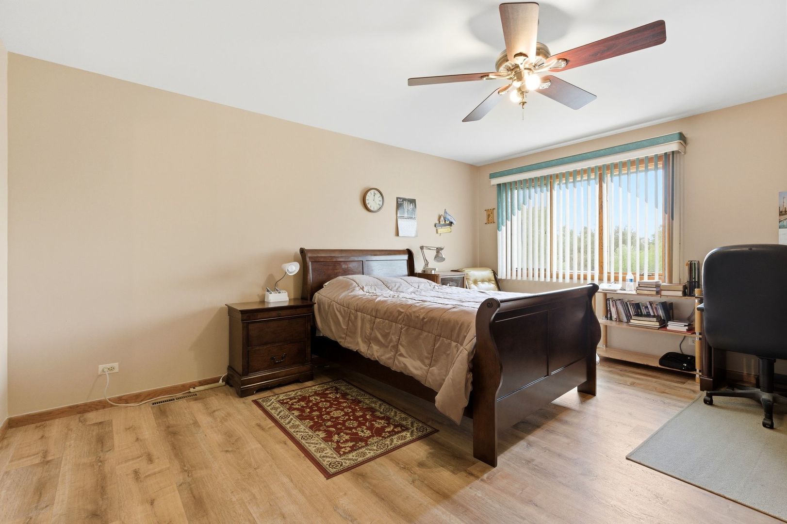 1735 Larson Lane Roselle, IL 60172 - Photo 14 of 35 a bedroom with a bed a chair and a chandelier