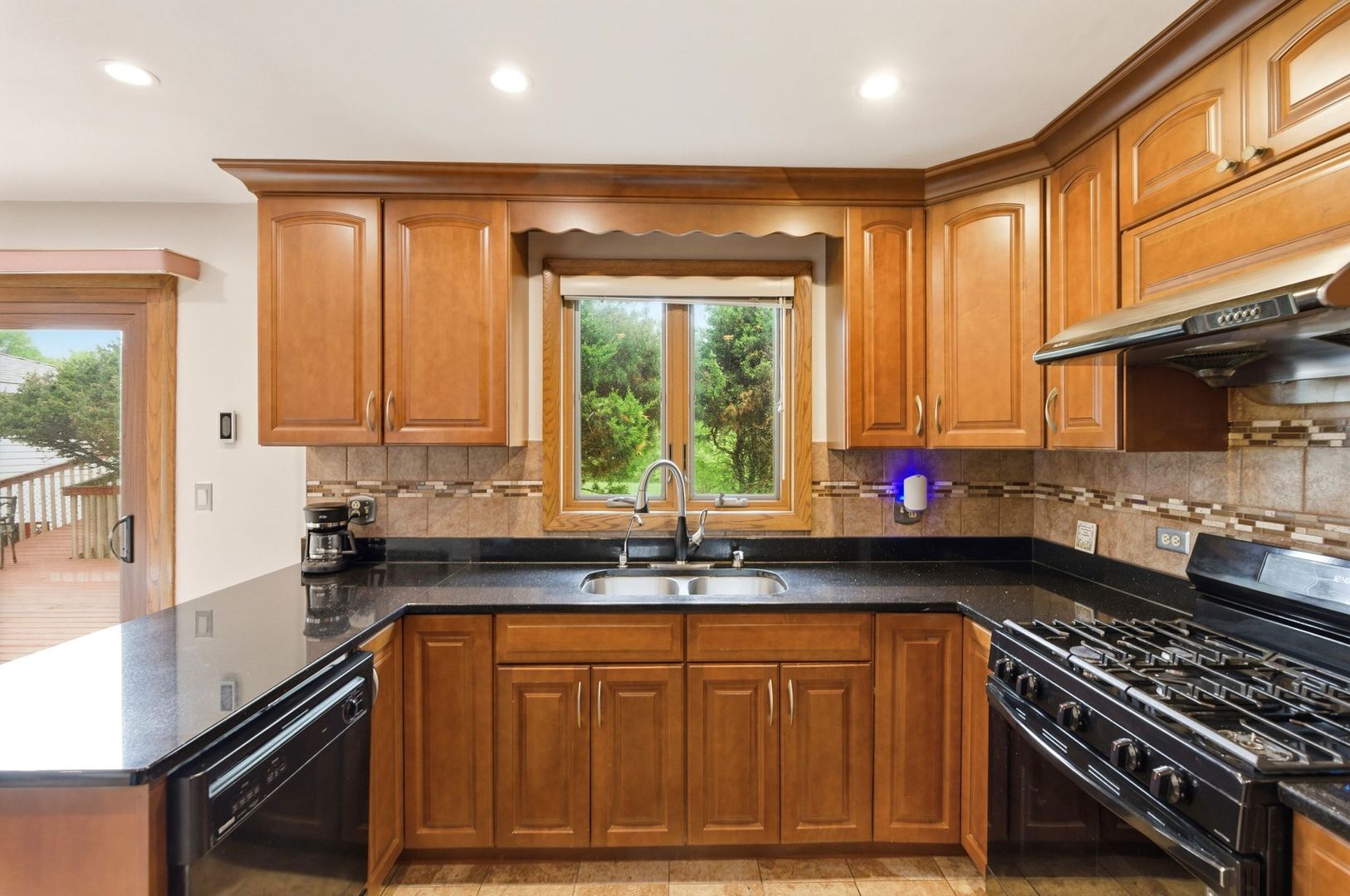 1735 Larson Lane Roselle, IL 60172 - Photo 4 of 35 a kitchen with stainless steel appliances granite countertop a sink a stove cabinets and a counter top space