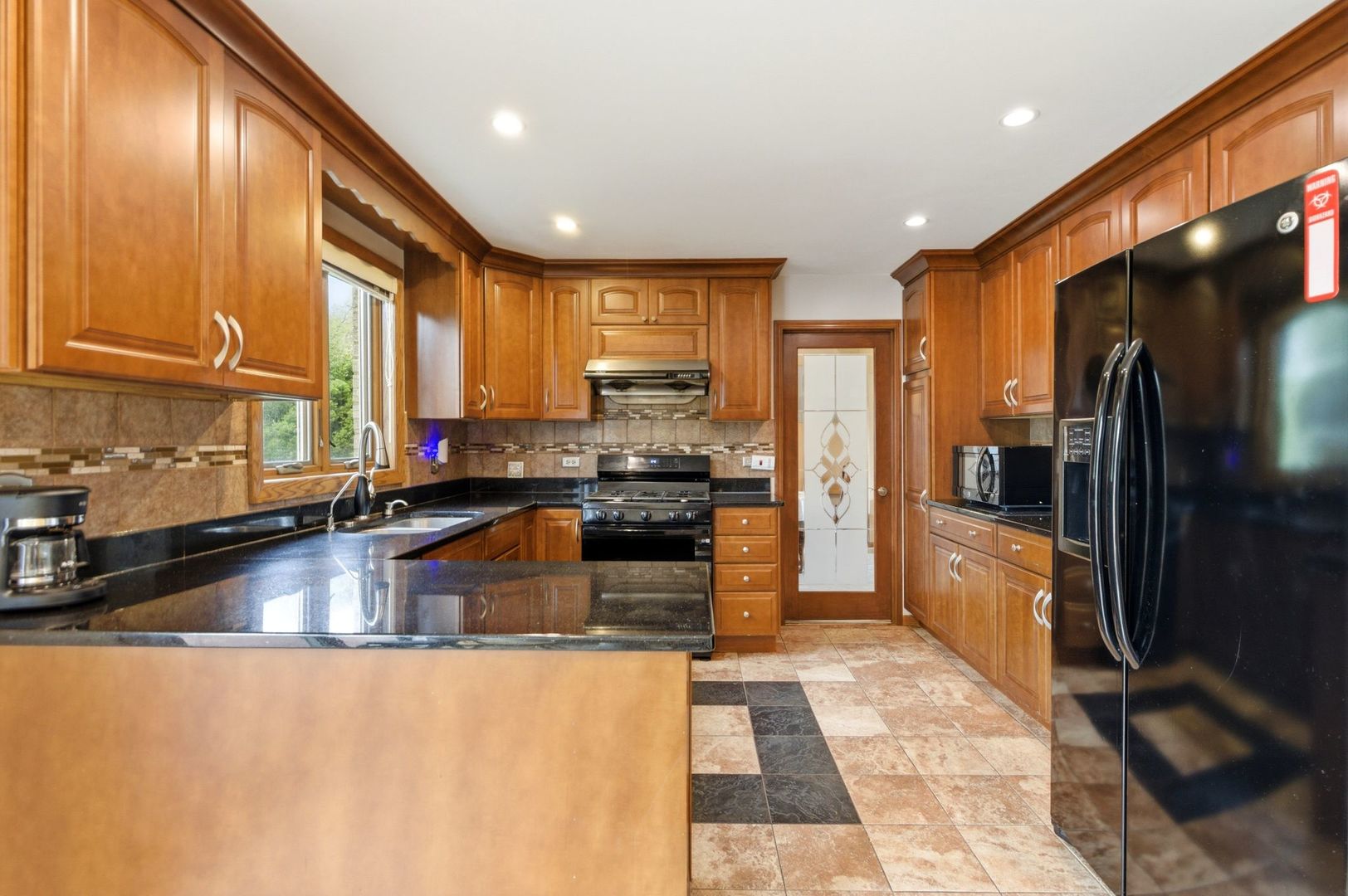 1735 Larson Lane Roselle, IL 60172 - Photo 5 of 35 a large kitchen with a large counter top stainless steel appliances and cabinets
