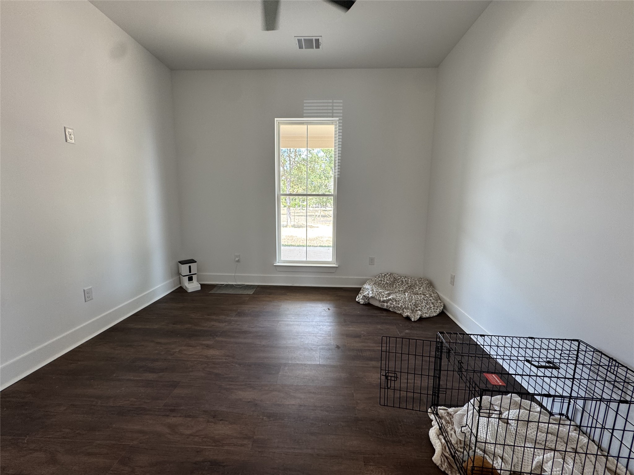 1353 Red Town Road, Unit B Elgin, TX 78621 - Photo 19 of 26 Rich wood floors lay a beautiful foundation beneath high ceilings in this versatile room.