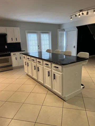 a kitchen with stainless steel appliances a sink a stove a microwave and cabinets