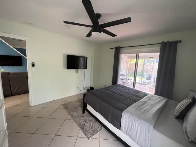 a bedroom with a bed and a flat screen tv