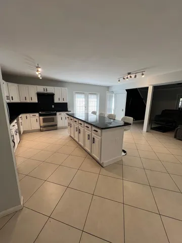 a kitchen with stainless steel appliances a stove a sink and a refrigerator