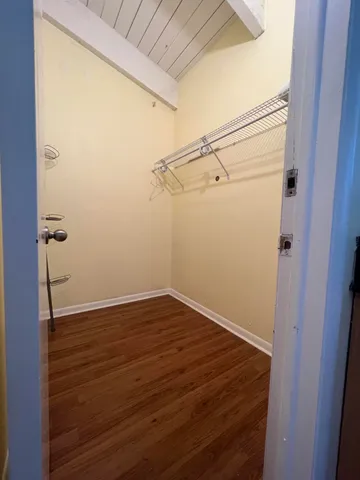 a view of a room with wooden floor and cabinet