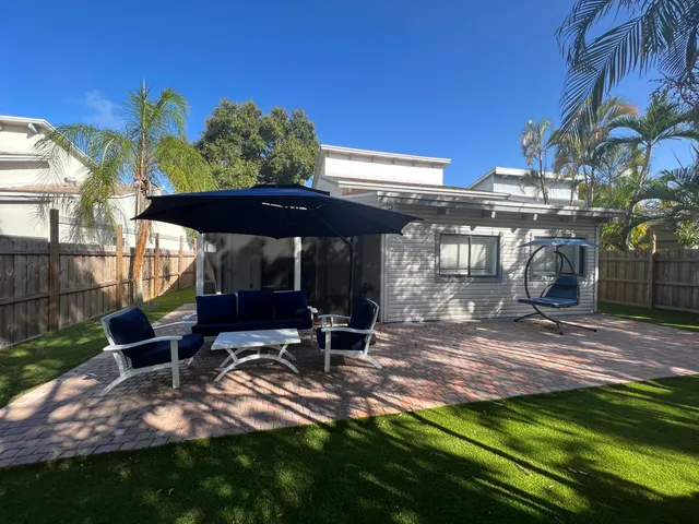 a view of a chairs and table in backyard of the house