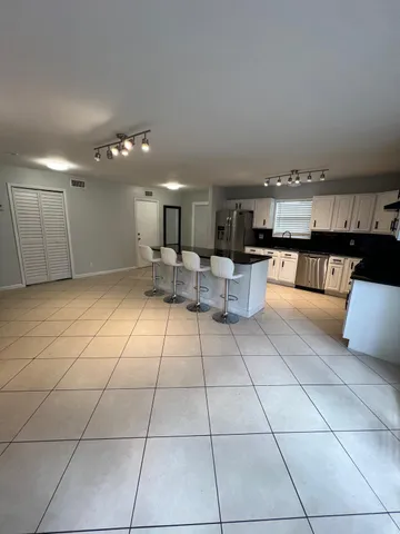 a kitchen with stainless steel appliances kitchen island granite countertop a sink and cabinets
