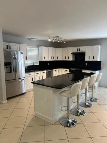 a kitchen with stainless steel appliances granite countertop a sink and cabinets