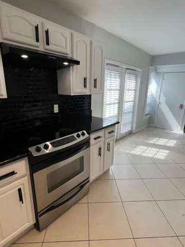 a kitchen with a stove and a cabinets