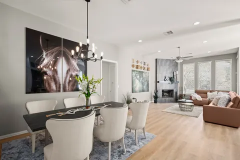 a living room with furniture a chandelier and a dining room
