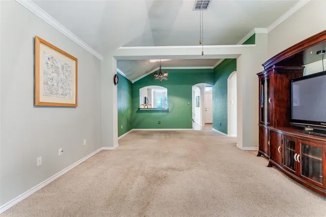 a view of a livingroom with furniture a flat screen tv and a chandelier