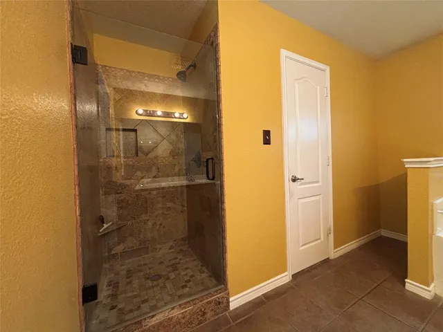 a bathroom with a glass door shower