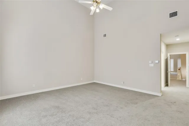 a view of a room with a chandelier fan