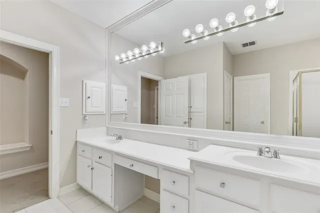 a bathroom with a sink double vanity and a mirror