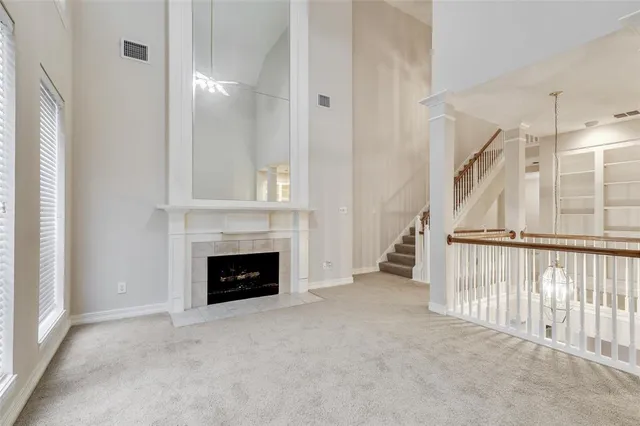a view of a livingroom with an empty space and a fireplace