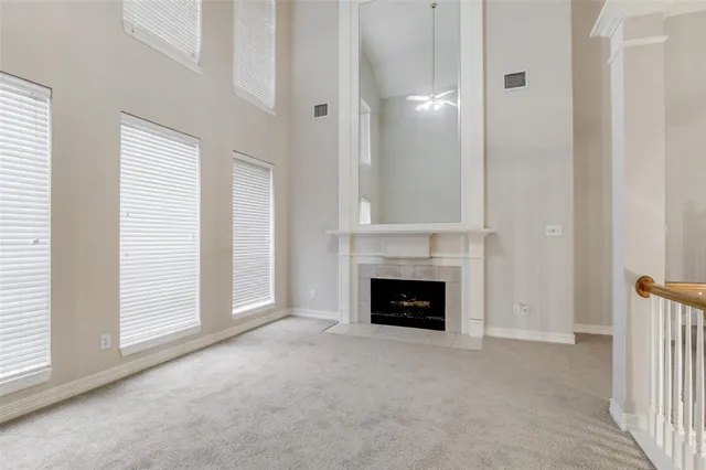 an empty room with fireplace and window