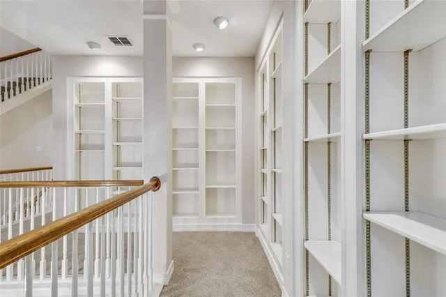 a view of a hallway with windows and entryway