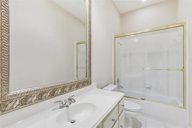 a bathroom with a sink mirror toilet and bathtub