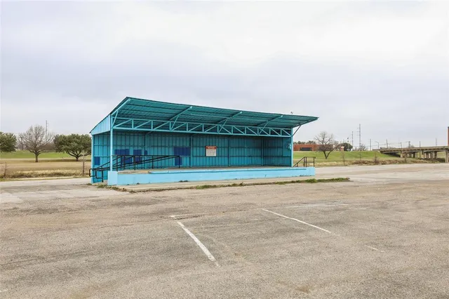 a front view of a house with a yard and mountain view